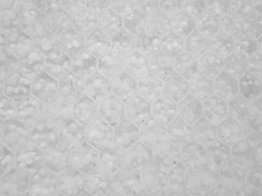 Close-up of a hexagonal honeycomb core panel filled with white granular beads, from the 1996 DERA tests.